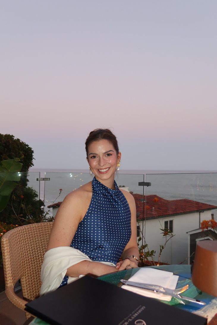Emily in a blue polka-dot top at dusk