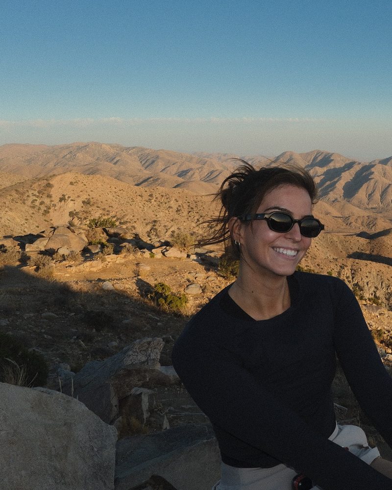 Emily Williamson in the desert — sunglasses and black top